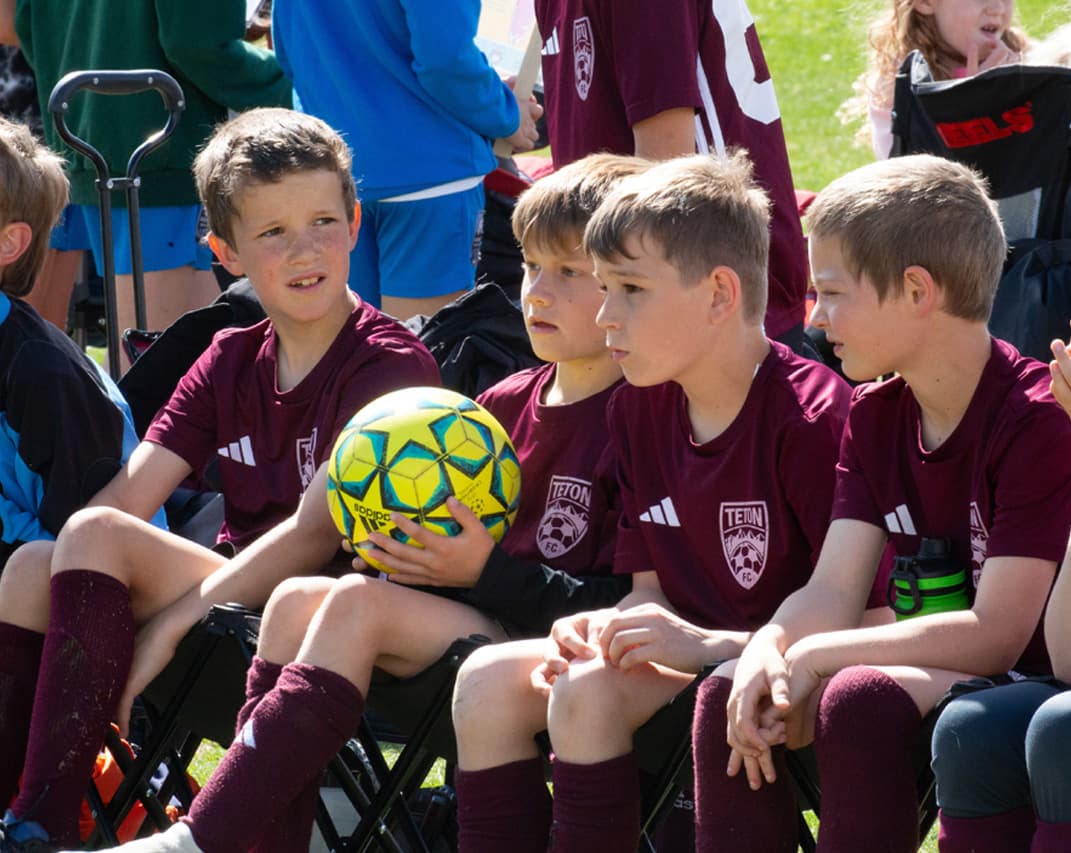 Boys on the sideline of a soccer game
