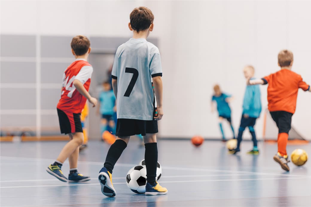 Kids playing futsal indoor soccer with Teton FC