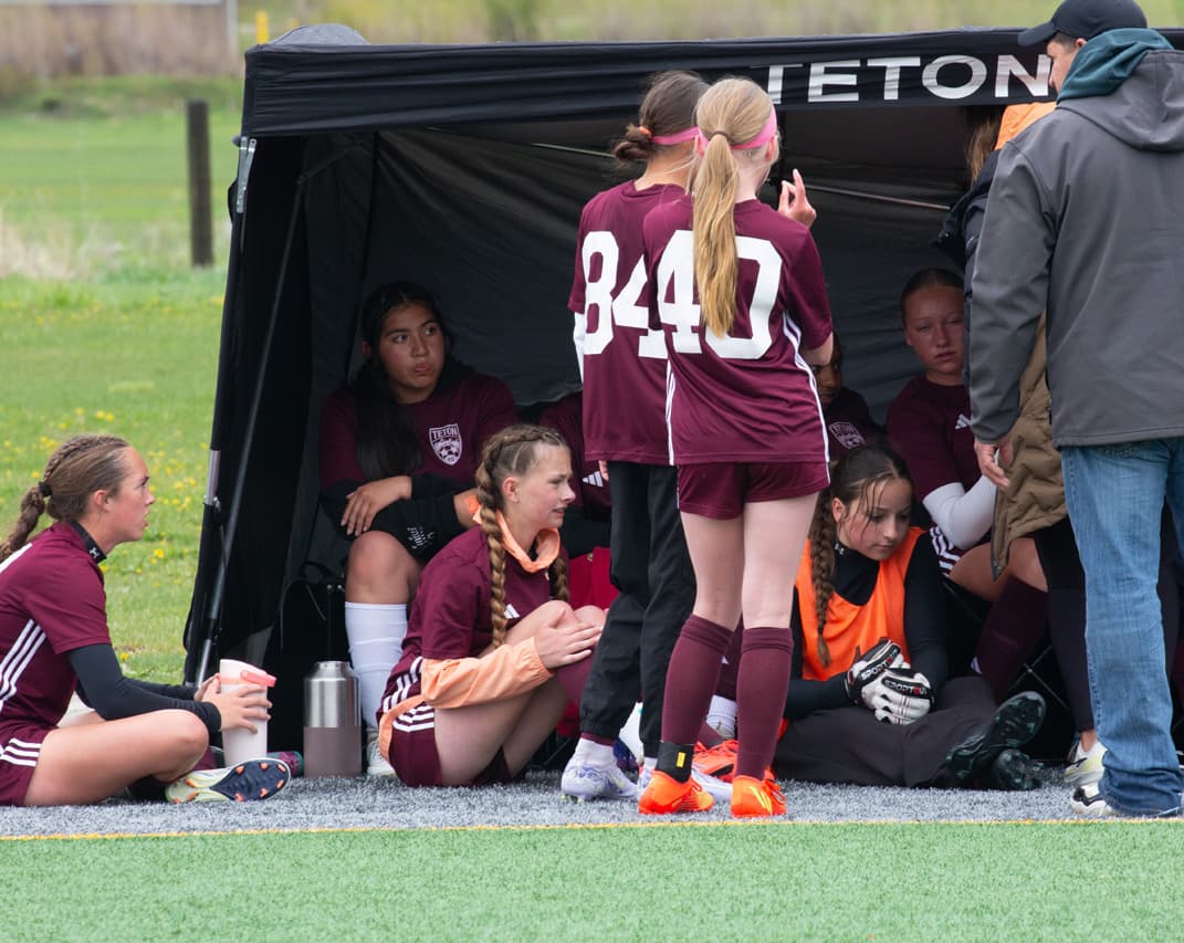 Soccer players on the sidelines of a Teton FC soccer game